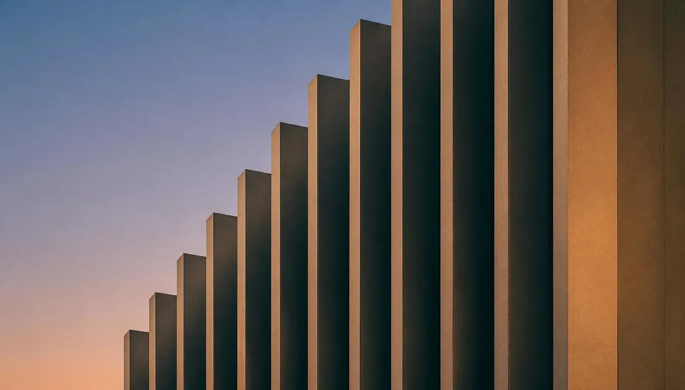 Vertical fins of a modern building facade at dusk